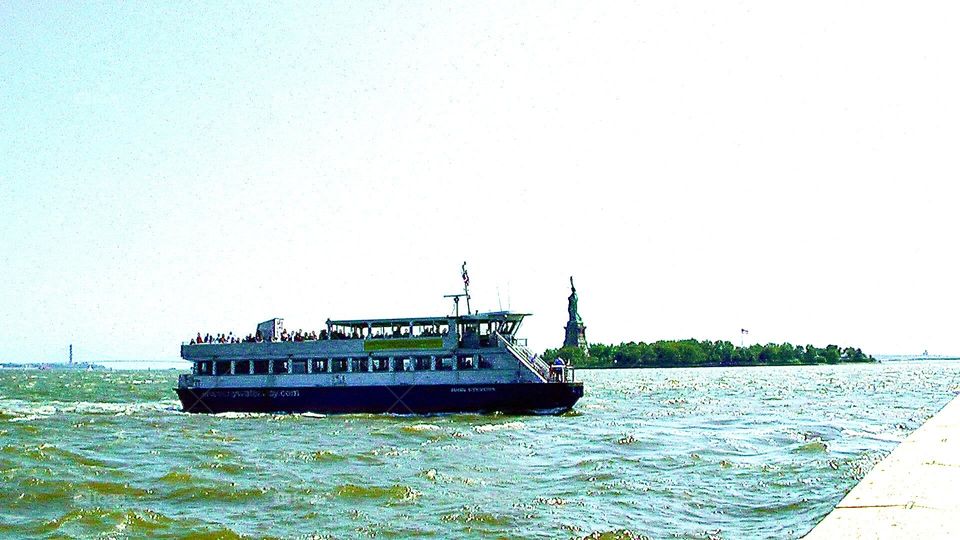 Ferry in New York Harbor transporting tourists to LibyIsland to visit Statue of Liberty 