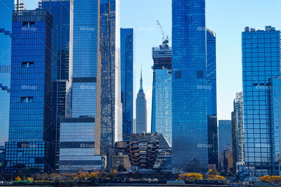A photo of Midtown Manhattan looking past the Vessel straight on to the world famous Empire State Building