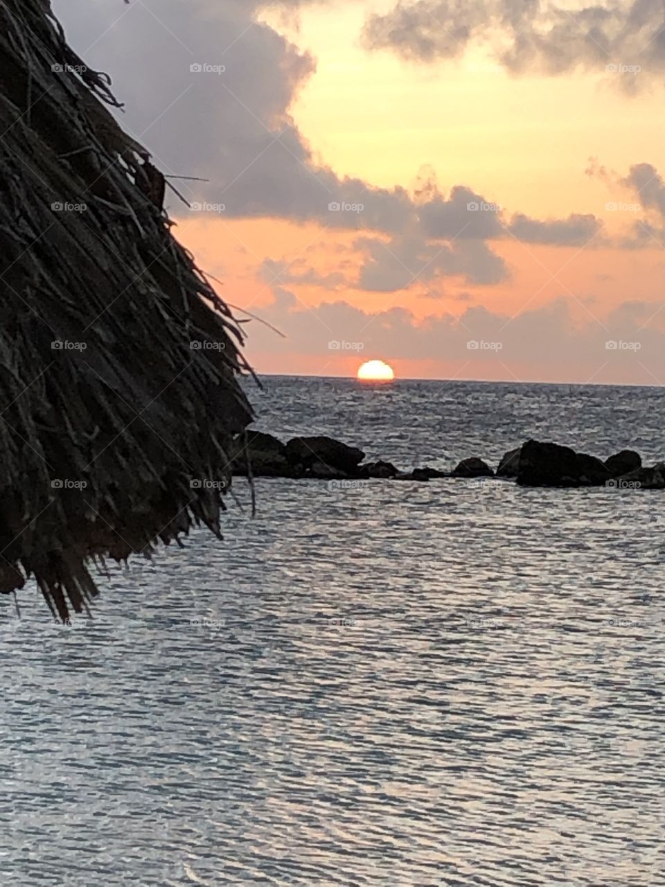 Caribbean sunset over the horizon with a colorful sky 