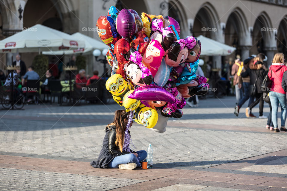 Girl sells balloons