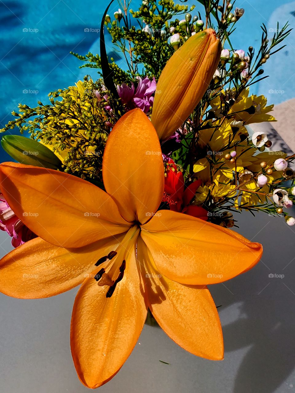 Beautiful spring bouquet sits poolside on a warm Arizona day