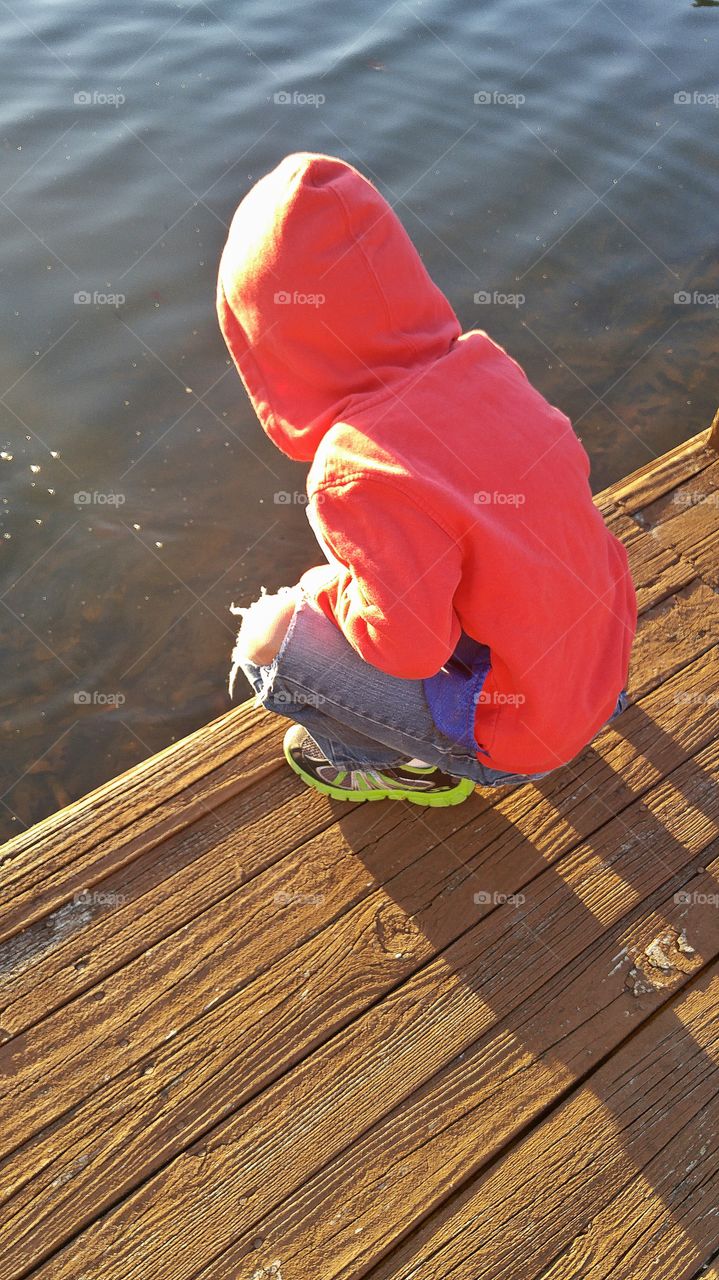 Child on a Dock at a Lake