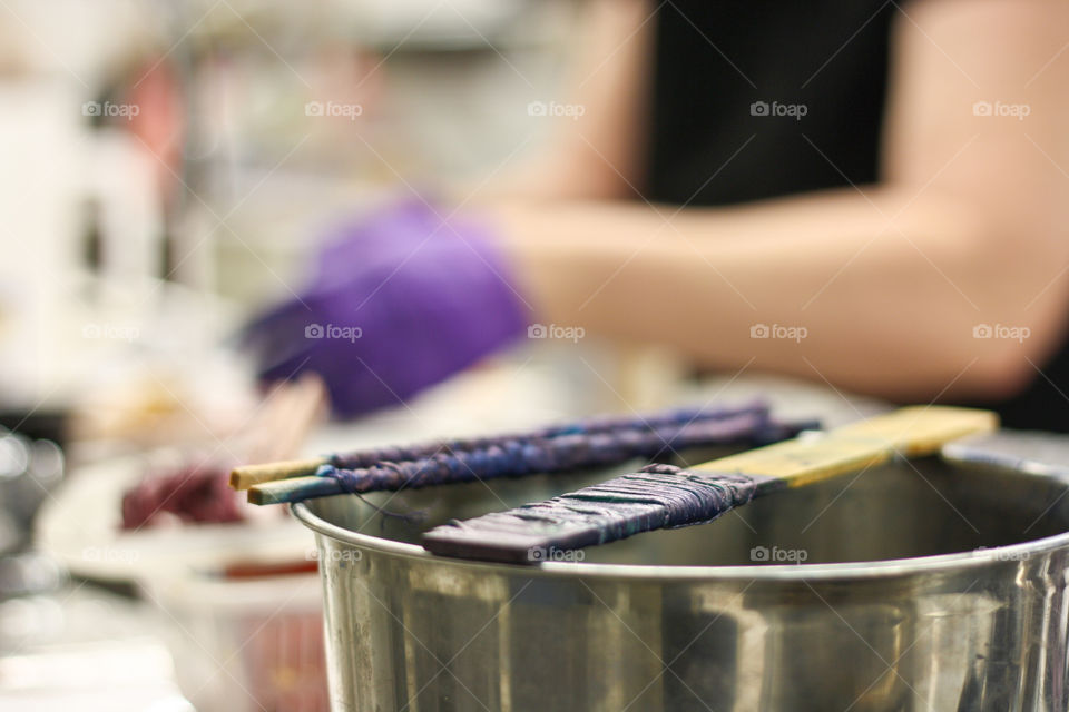 Hand rinse dyed textiles in the background while newly dyed pieces wait to be rinsed in the foreground 