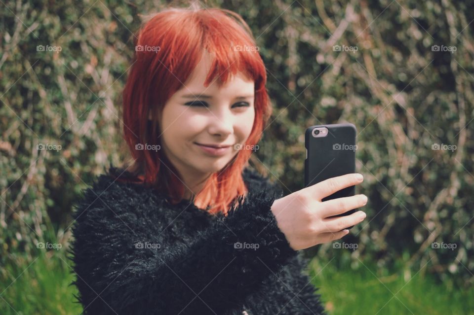 Girl taking a selfie with her phone