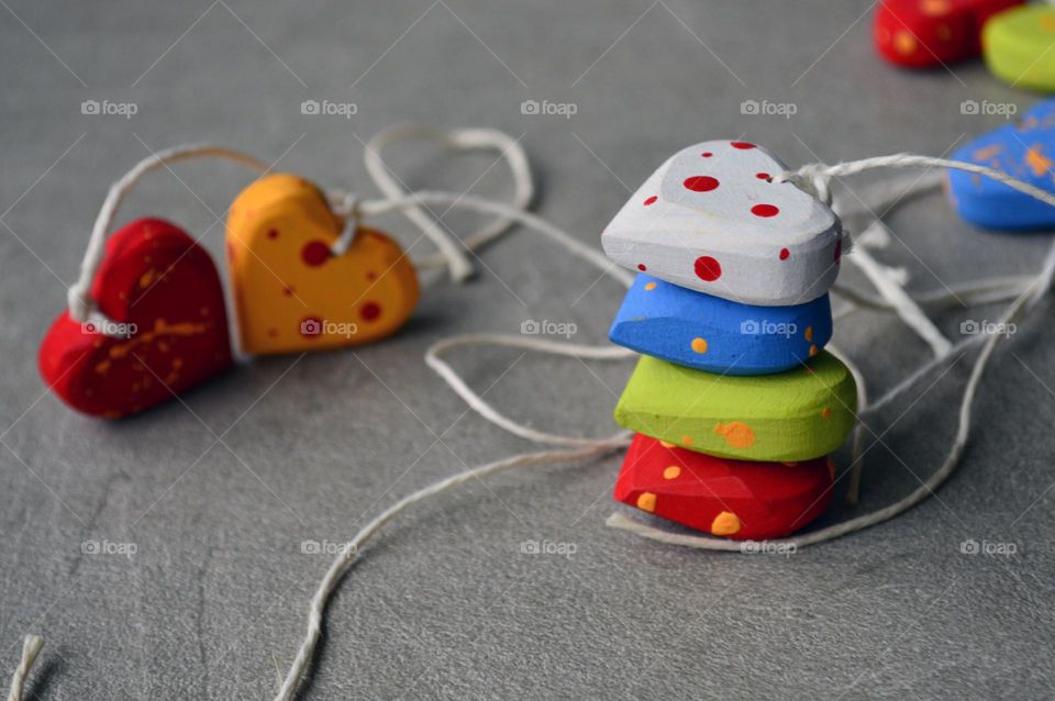 Multicolored wooden hearts on a thread