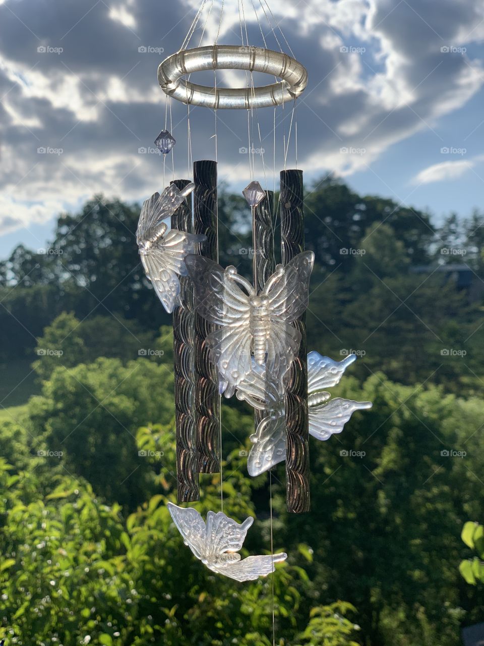 A butterfly wind chime on a sunny day at a friend’s house. The sun hit it just right.