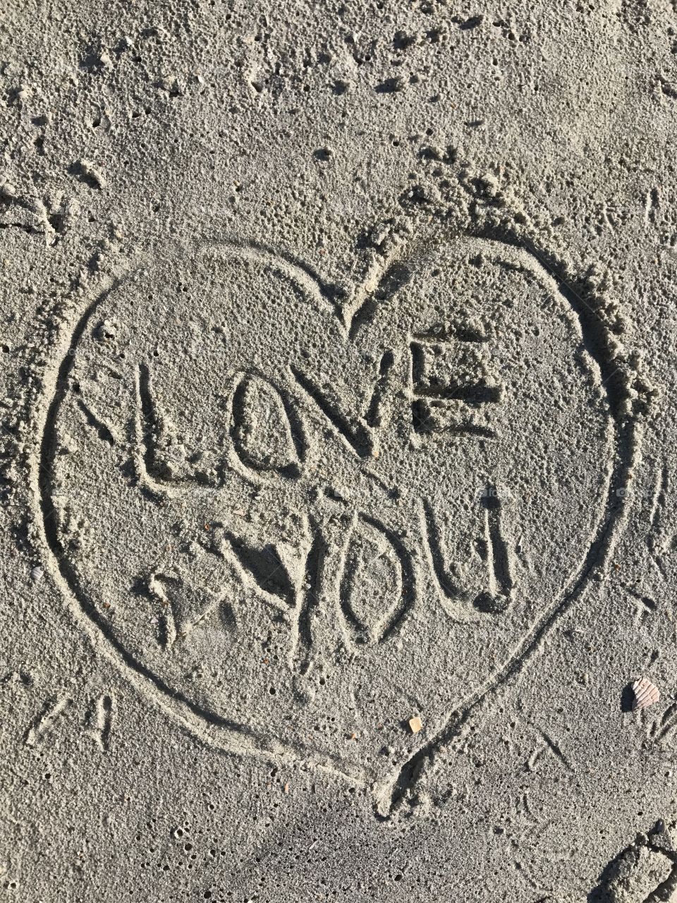 Love you written in sand. 