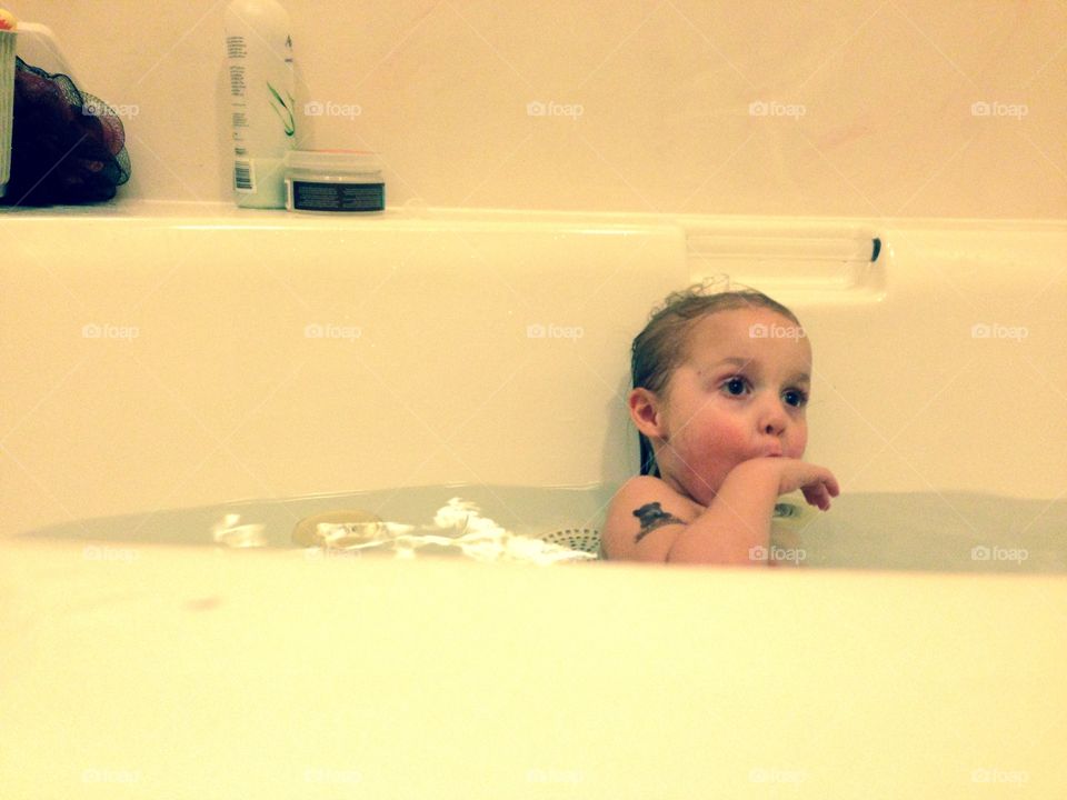 No suds . A child taking a bath 