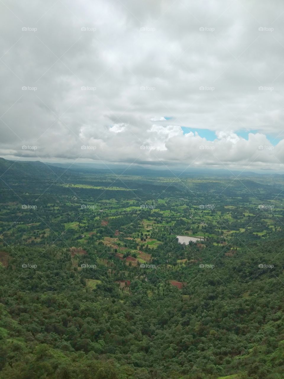 View from the top of the hill full of clouds.