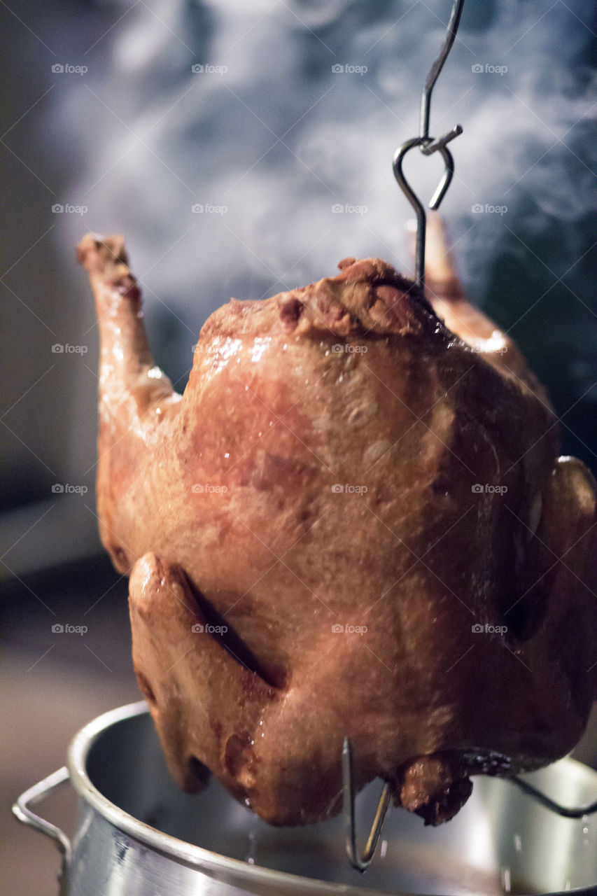 pulling the turkey from the deep fryer