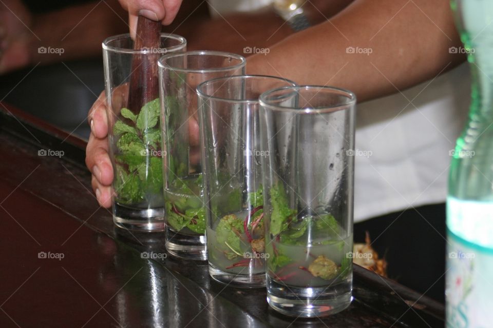 A bartender preparing mojitos
