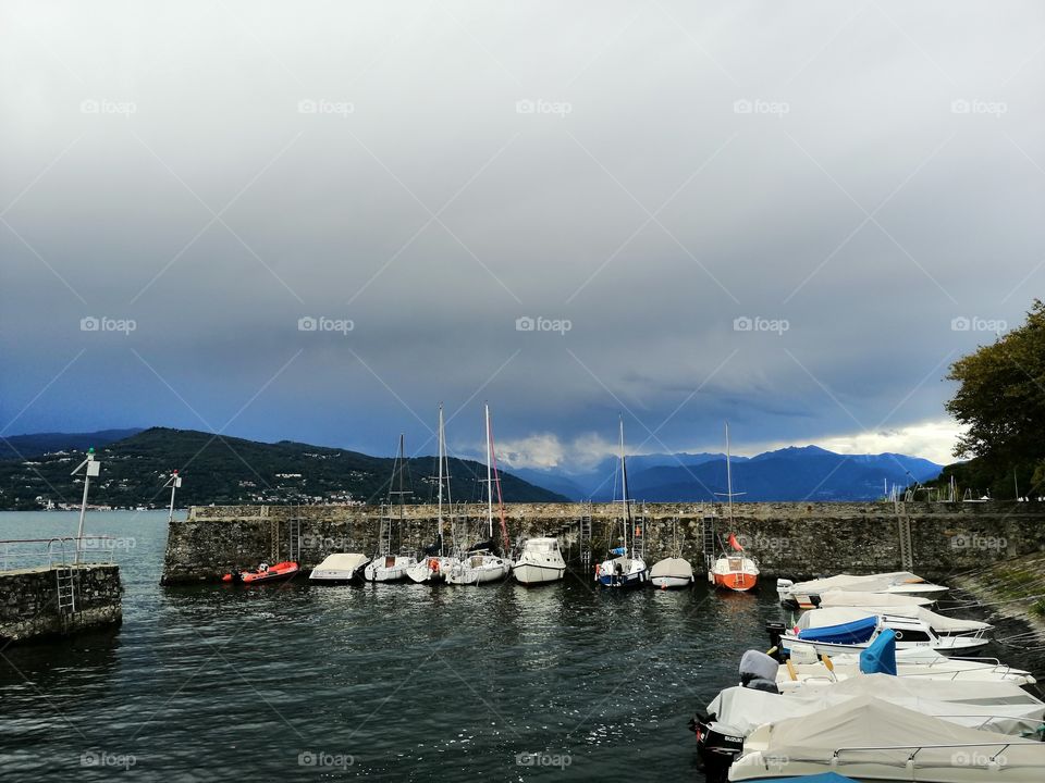 Piers with boats at Lake Maggiore in Italy.