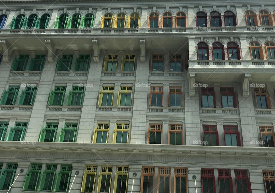 A colourful building with different colours of windows.