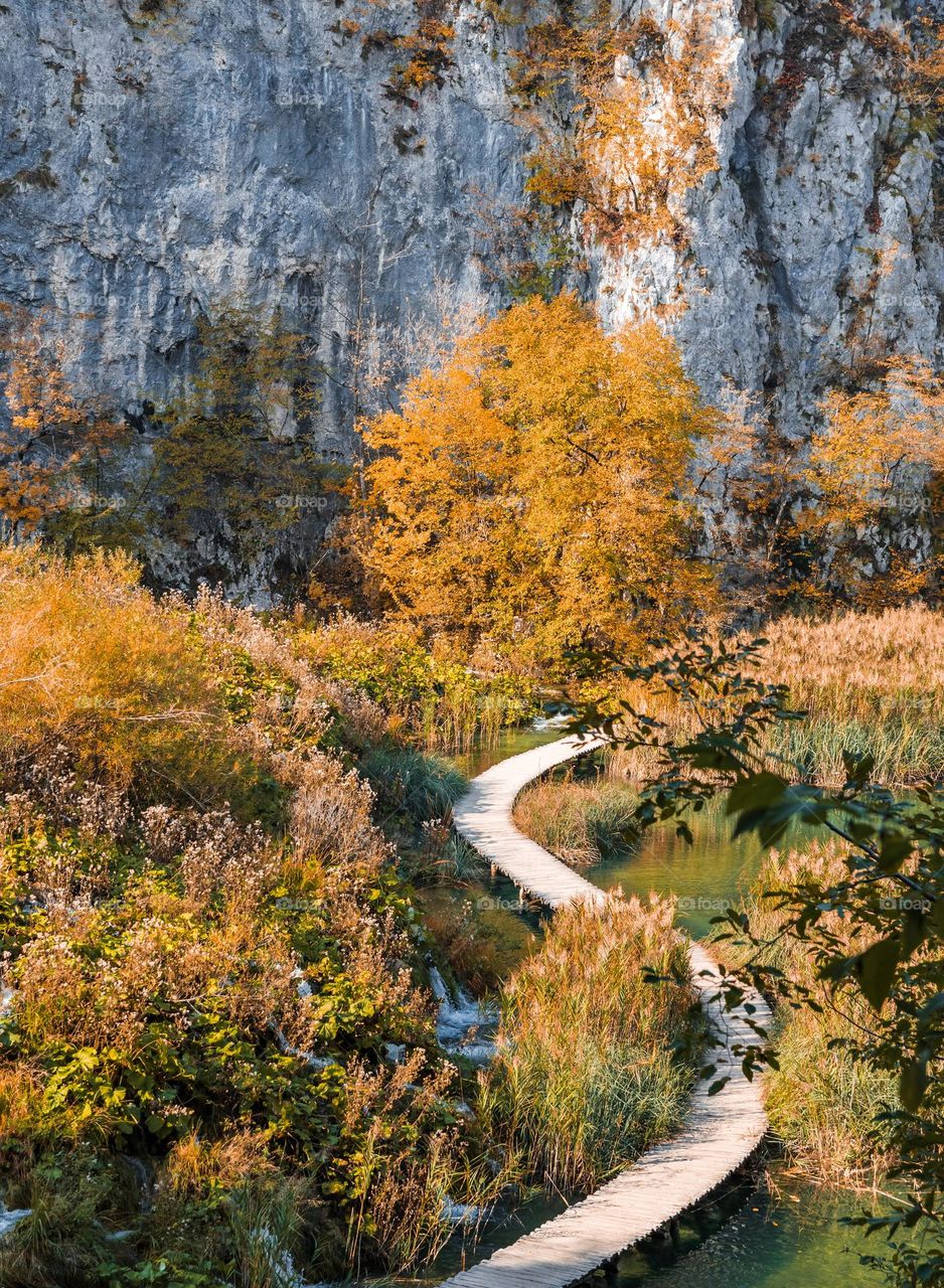 Wooden pathway across lake at Plitvice lakes national park in Croatia in autumn