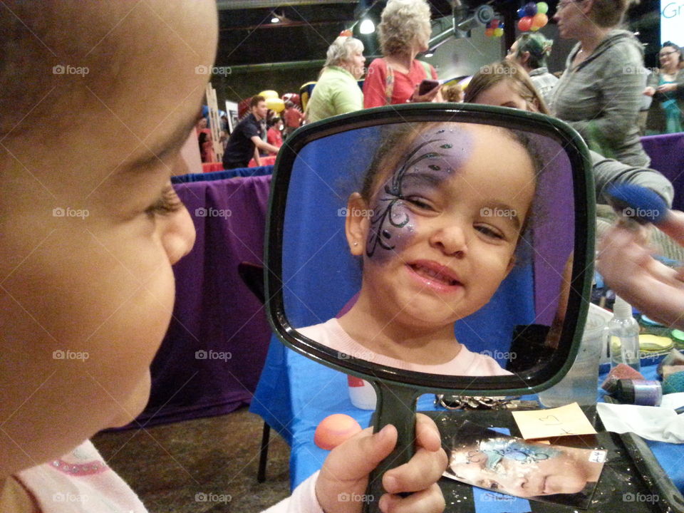 Cute girl looking at the mirror