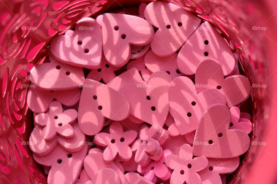 pink color wooden buttons hearts  pink background