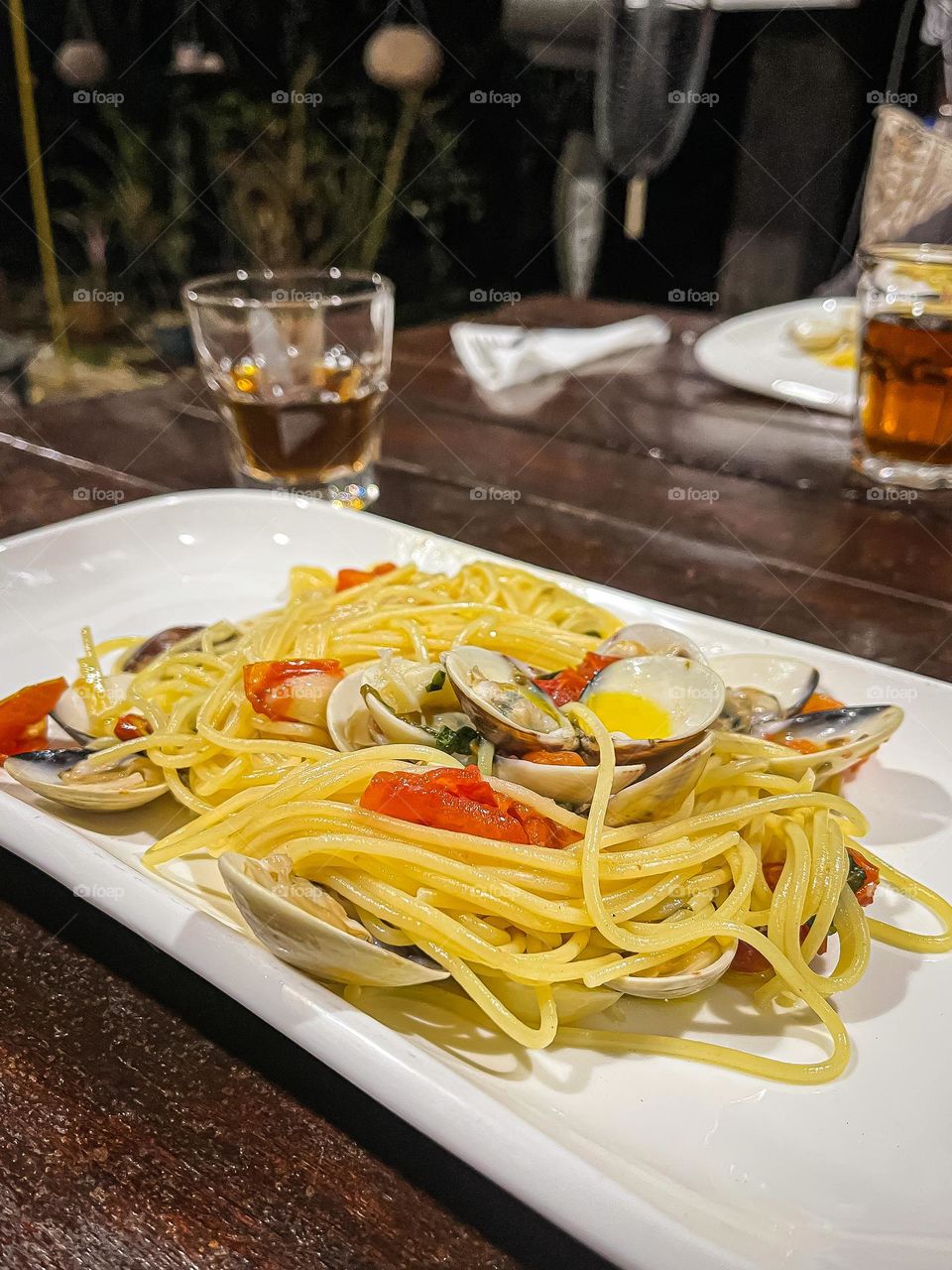 Spaghetti with clams in a white plate for dinner 
