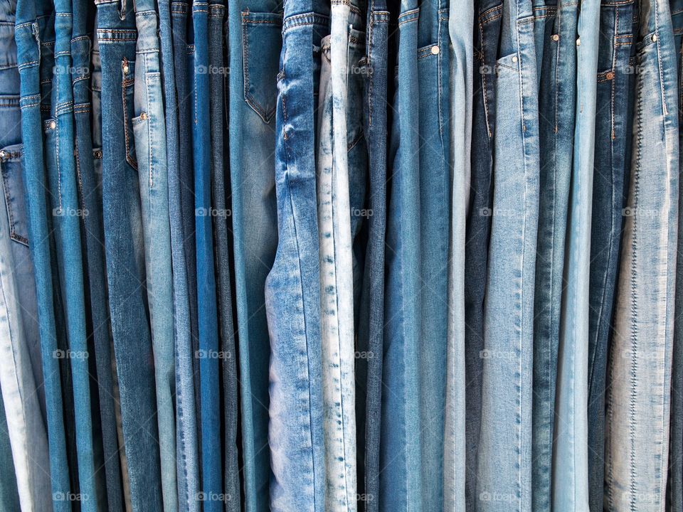 Variety of hanging denim jeans