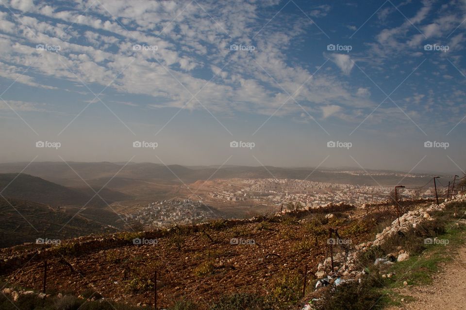 overlooking an Arab town and Israeli settlement outside of Jerusalem