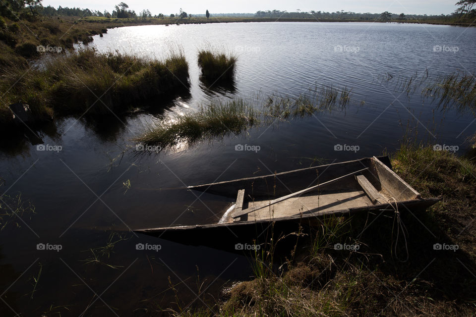 Broken boat in the pond