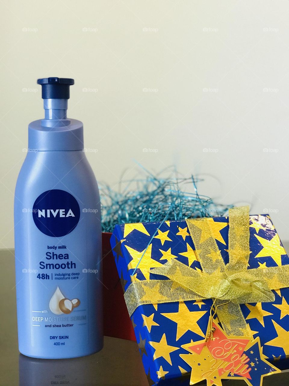 Nivea shea smooth lotion beside that a blue gift box labeled as For you.