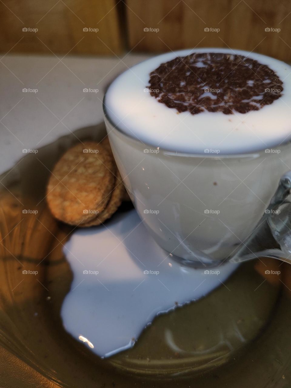 a cup of milk with cookies
