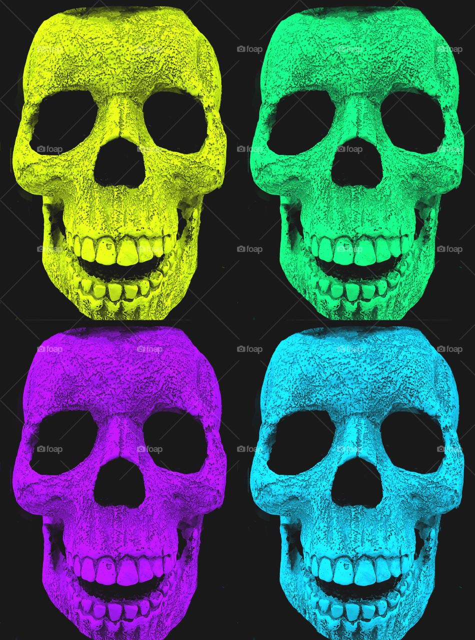 Multiple human skulls. Multiple multicolored human skulls.
