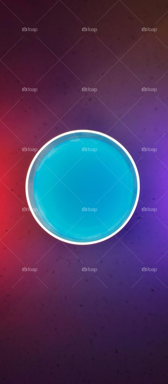 blue circle with white outline on the background of a color gradient
