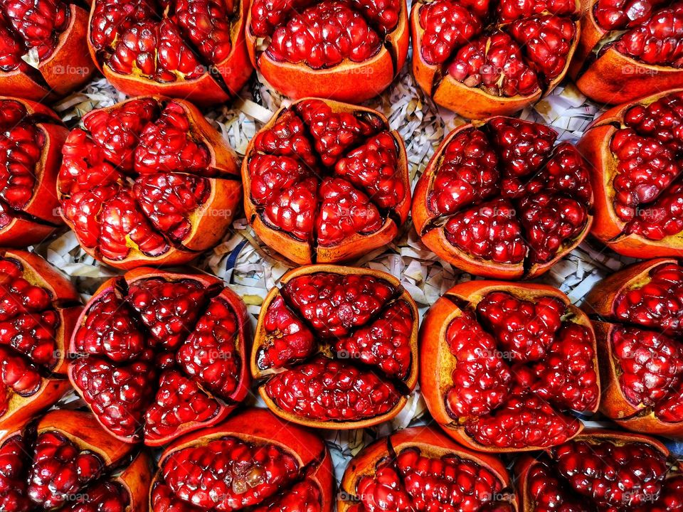 bright red open pomegranates photographed from above