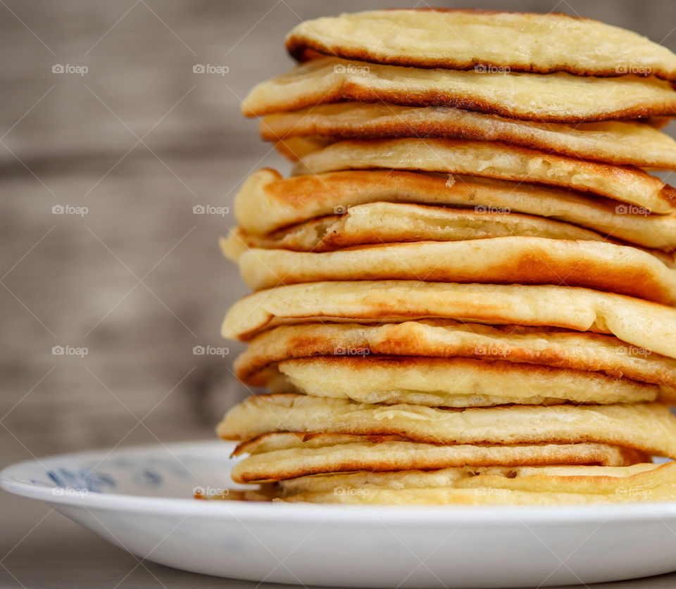 Pile of a freshly made golden pancakes on a plate