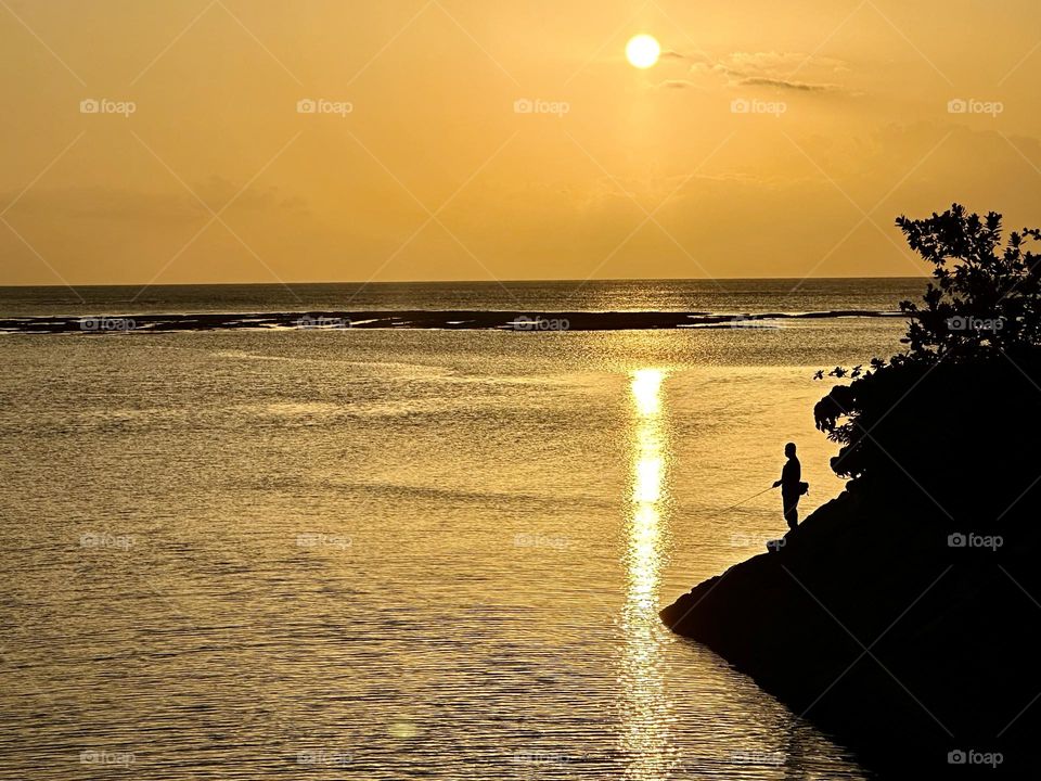 A fisher man and sunset