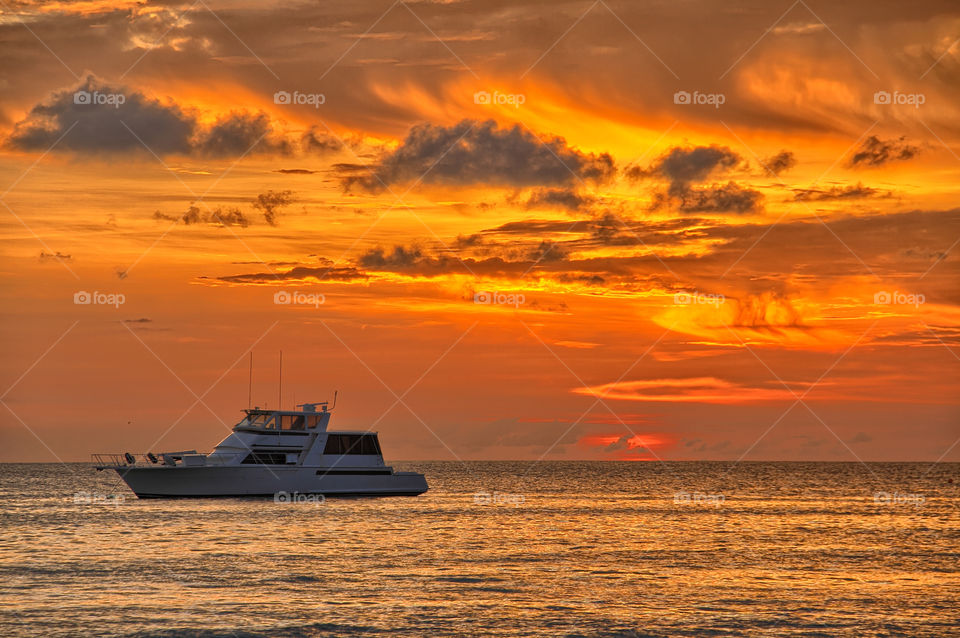 Boat in sea during sunset
