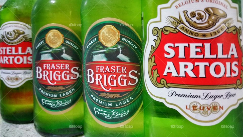 Stella Artois and Fraser Briggs lager beers photographed side by side. Image backlit.