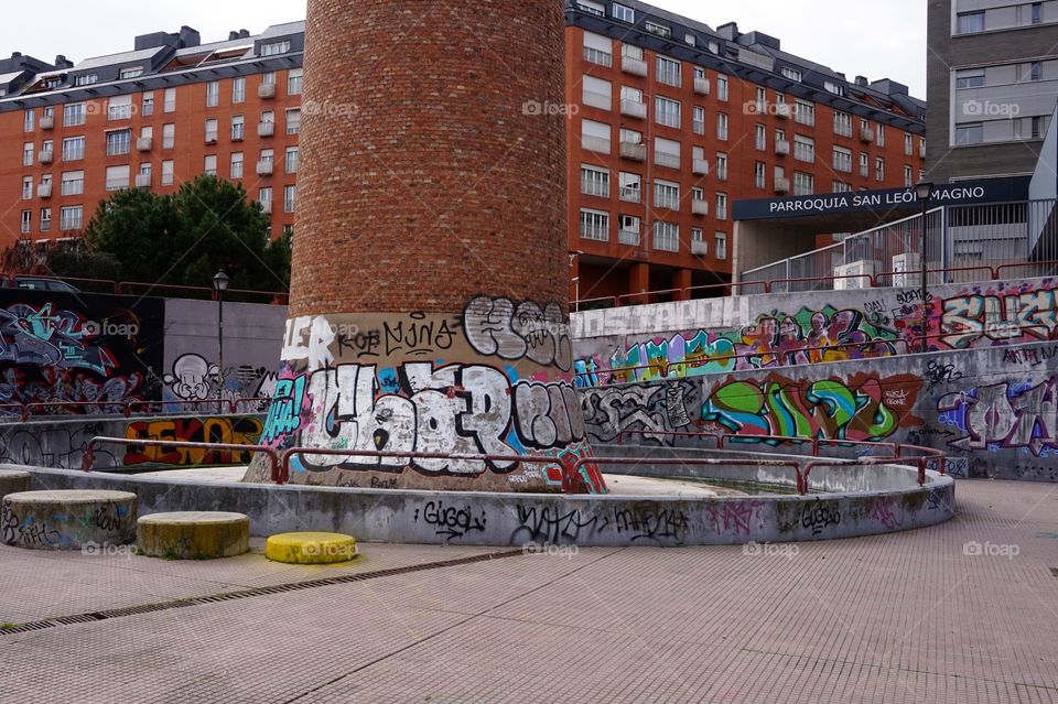 Graffiti around the base of an old smokestack, Jardín del Rastro, Madrid 