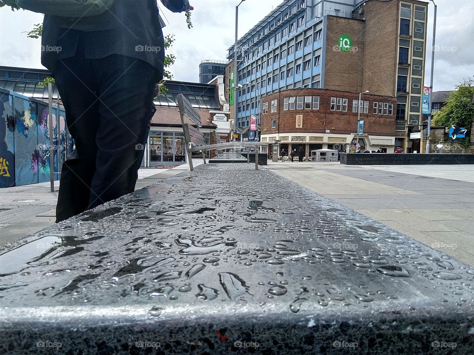 water droplets on a slab next to some chairs