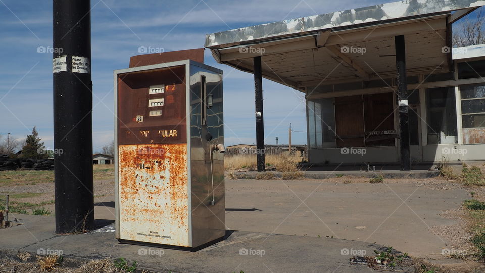 Regular Fuel gas pump. Abandoned roadside gas station with rusty old gas pump