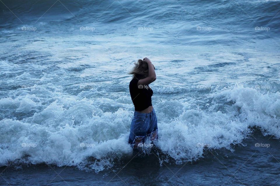 Waves crashing around girl