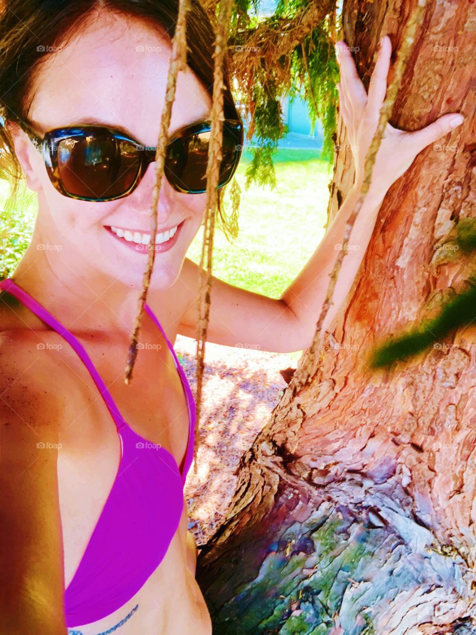 Hot pink bikini girl just climbing a tree 