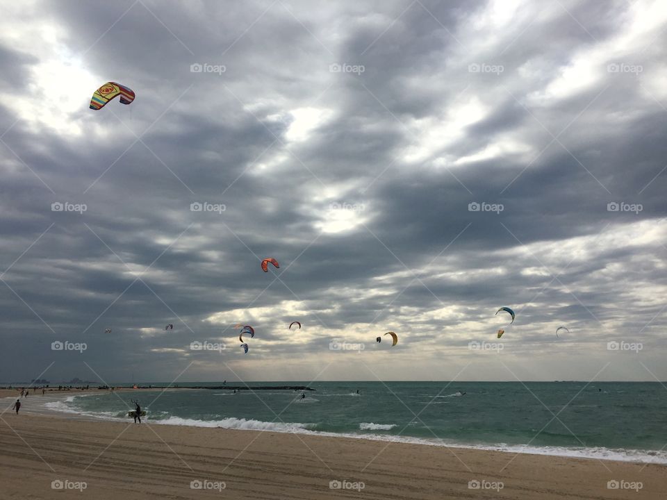 Kite flying at the beach on a cloudy day