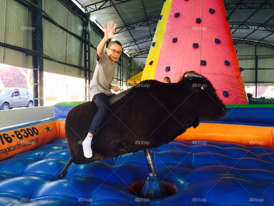 Boy riding on mechanical bull