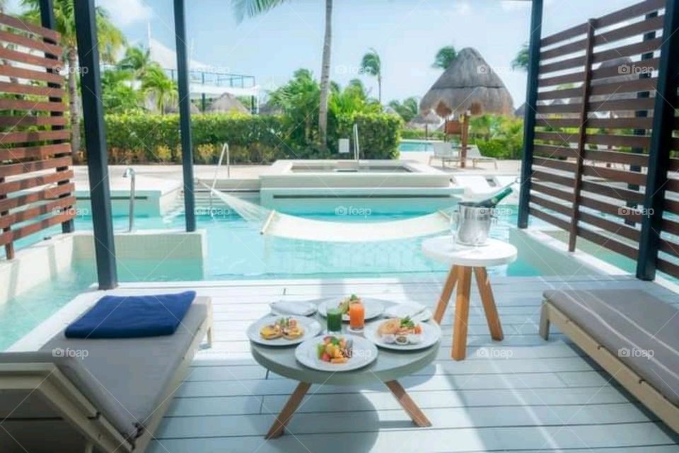 Luxury house with swimming pool outside, Breakfast in the table.