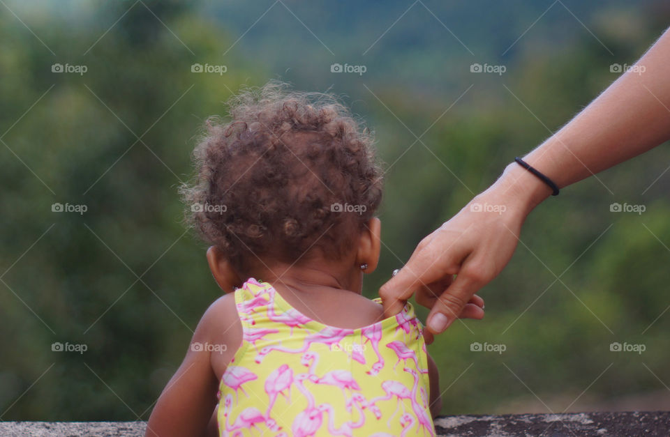 little Puerto Rican girl looks out over a cliff