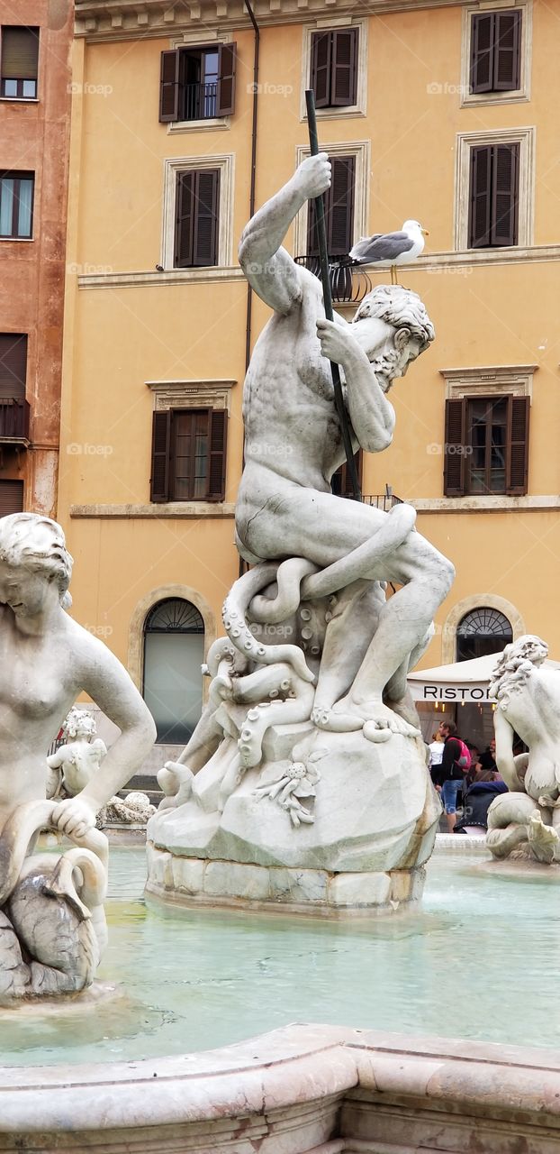 Statue details view of the famous Fountain of Neptune in Piazza Navona, Rome, Italy, Europe.