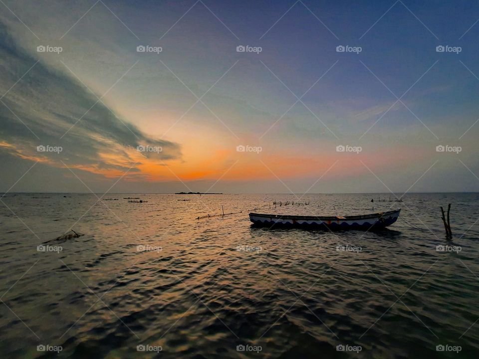 Breathtaking sunset making beautiful colours on sky and lagoon water. Evening time at the northern part of tropical wander, Sri Lanka.