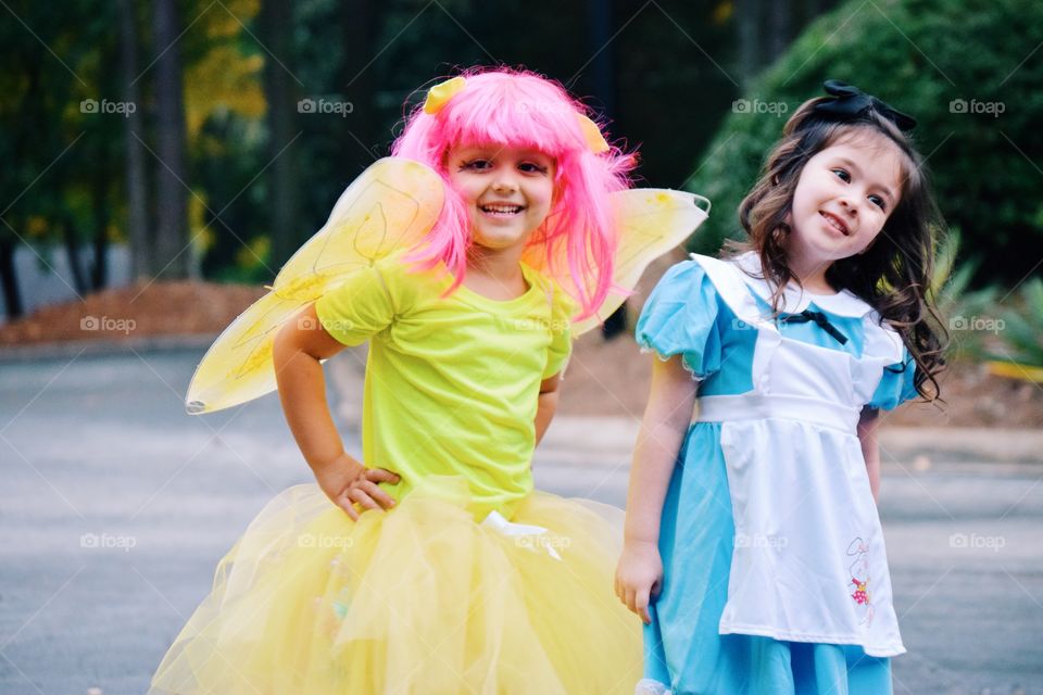 Cute girl in fairy wing standing with her friend
