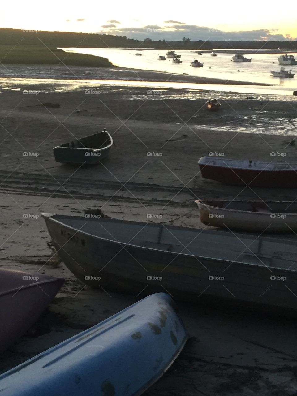 Boats on the beach at sunset 