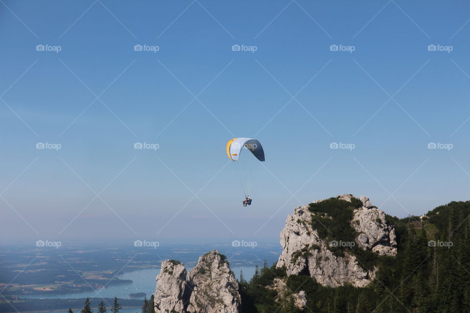 Paragliders flying against sky