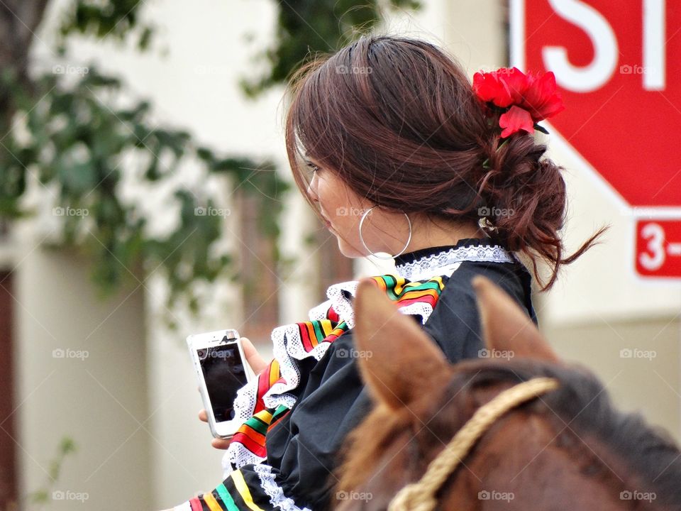 Cowgirl Taking A Selfie. Old Traditions Meet Modern Technology