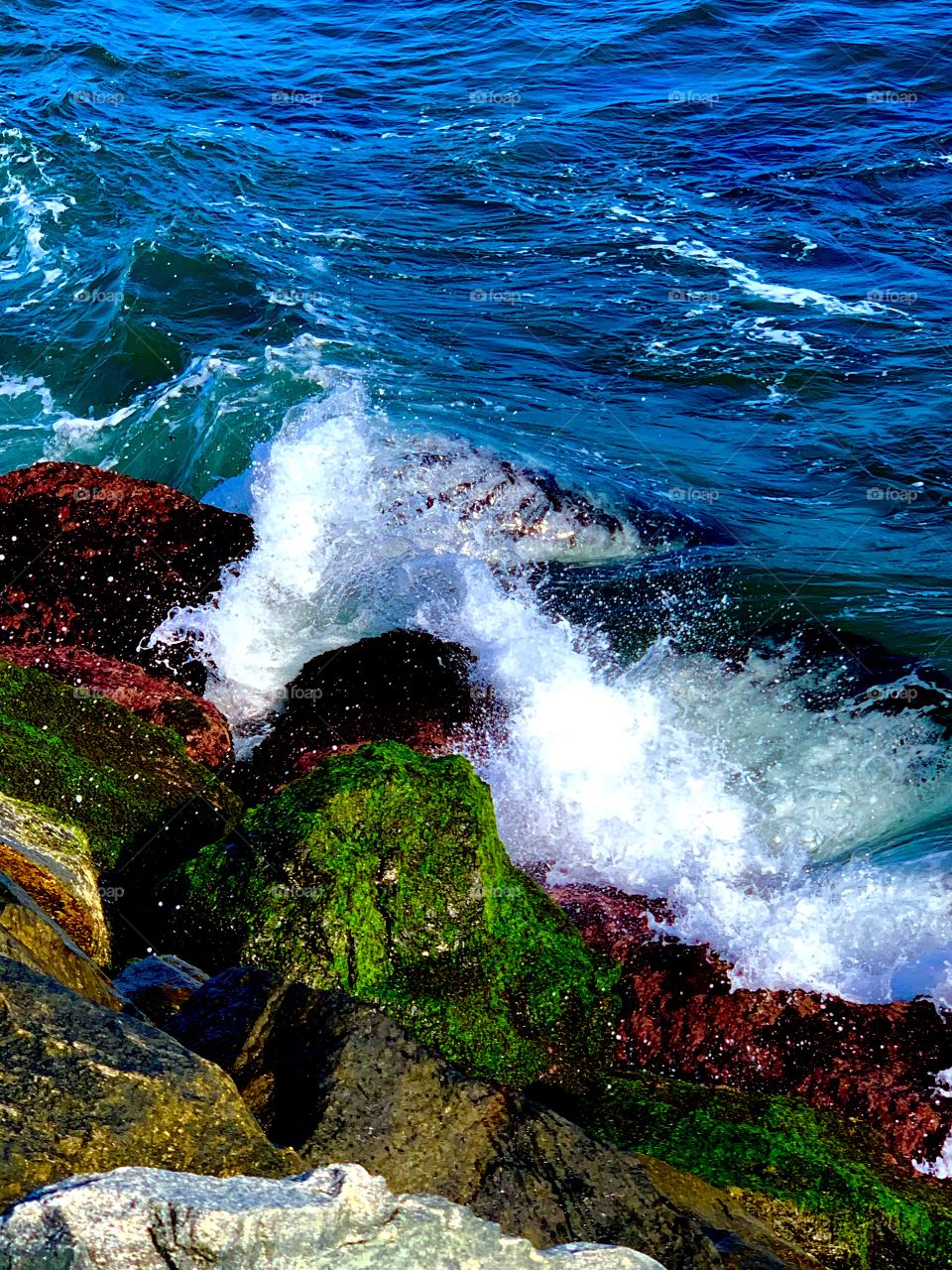 waves crashing on rocks on the shore