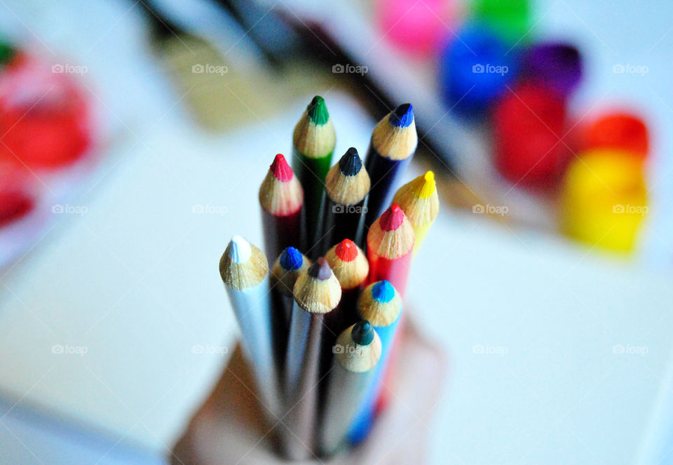 Art supplies, colored pencils, paintbrushes, paint, sketch book, watercolor pad, palette